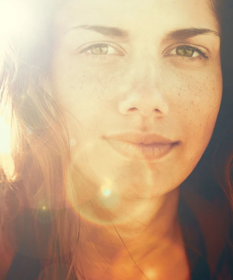 Beautiful woman with radiant skin enjoying natural golden sunlight for wellness and self-care lifestyle