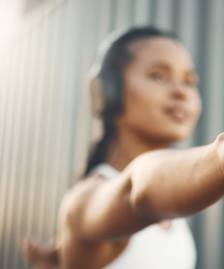 Professional woman extending welcoming hand gesture in urban wellness consultation setting