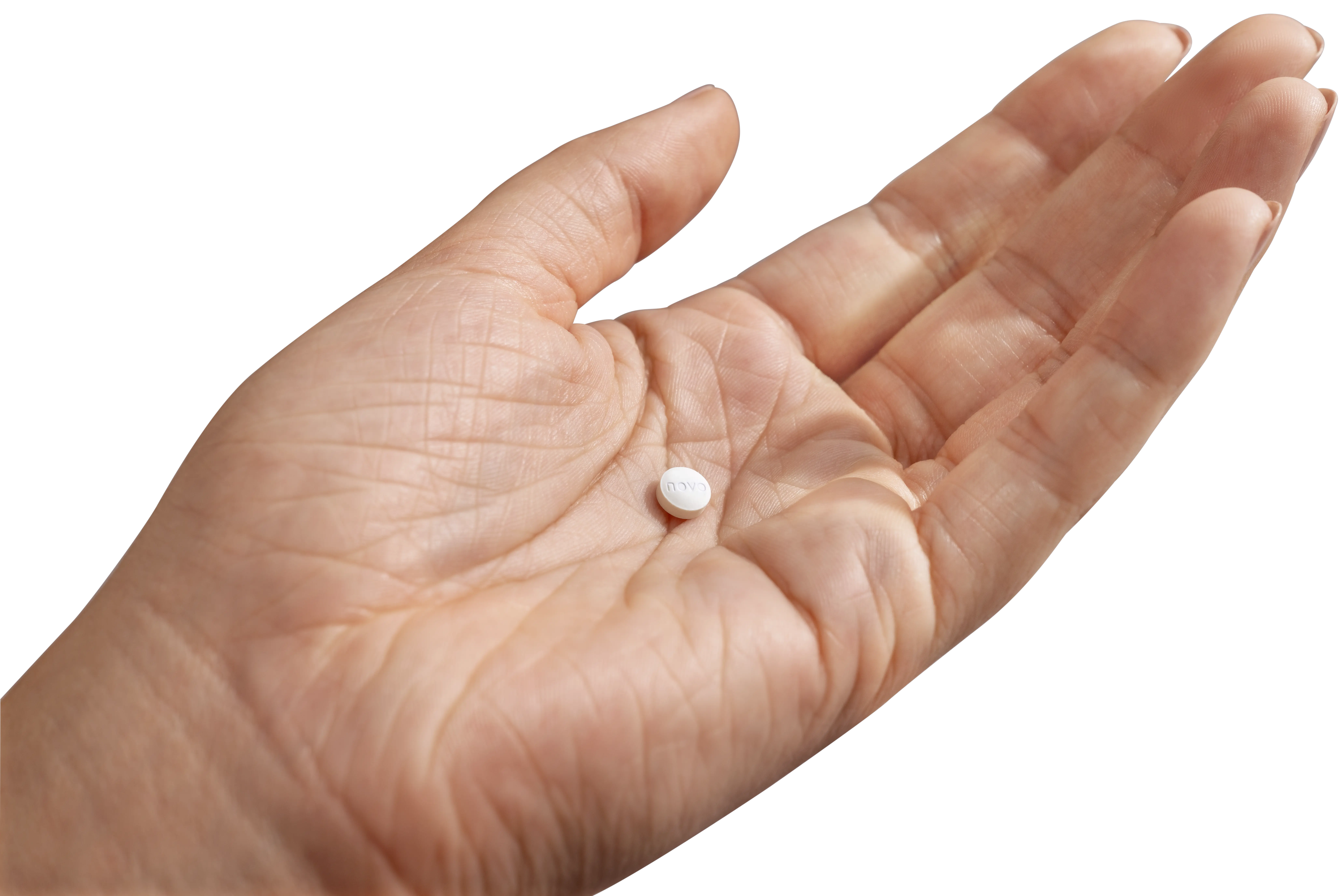Open hand holding a Wegovy® oral semaglutide tablet